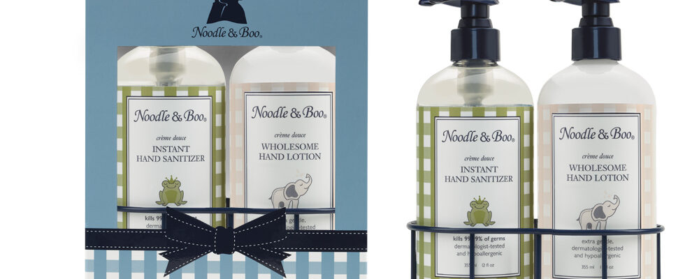Elegant hand soap and lotion set with botanical design and black ribbon.