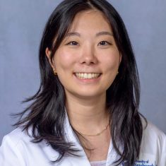 Smiling woman in a white coat