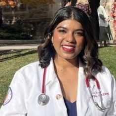 Smiling female doctor outdoors with stethoscope.